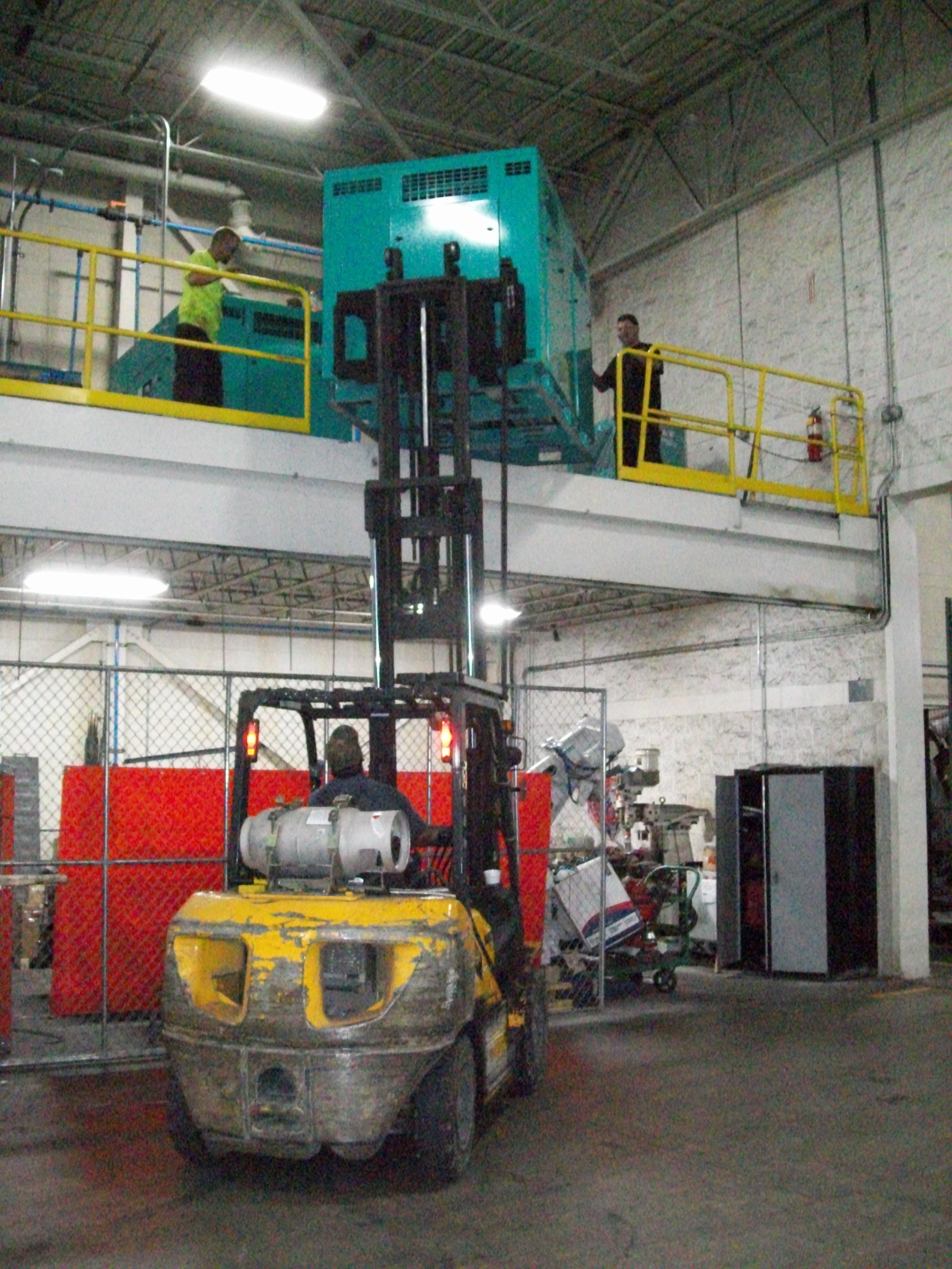 lifting a sullivan palatek SP16-75HP rotary screw air compressor up to mezzanine location
